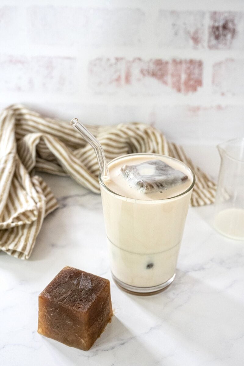 Iced chai latte using frozen chai concentrate in glass with a straw. 