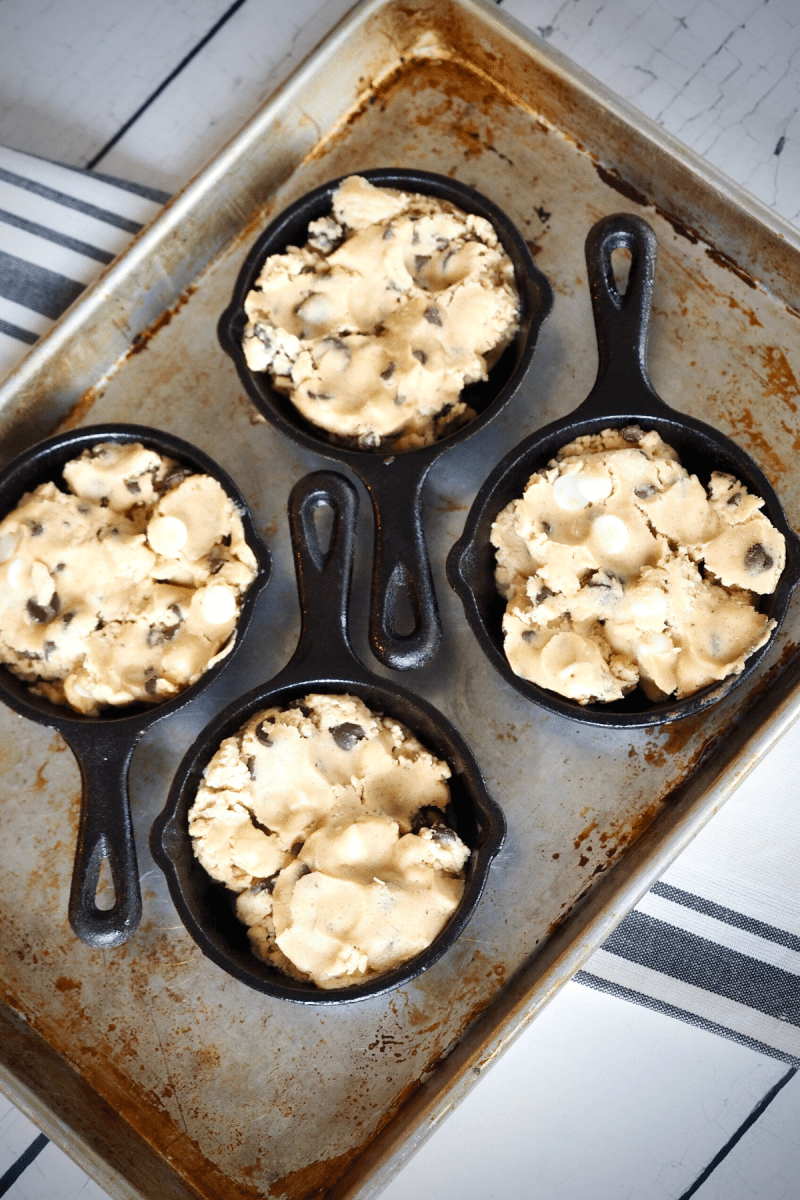 https://www.thefreshcooky.com/wp-content/uploads/2019/05/Cookie-Dough-pressed-into-mini-cast-iron-skillets-800x1200.png