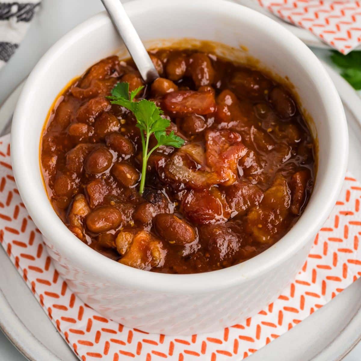Cowboy baked beans in a bowl with a spoon.