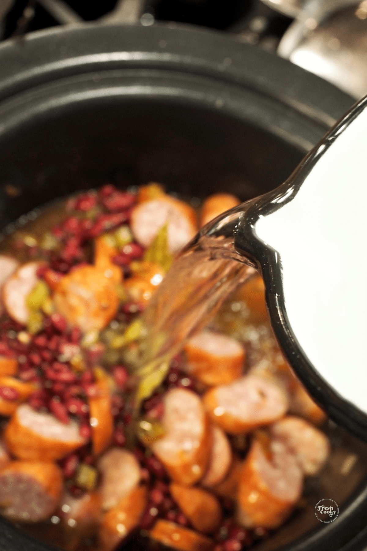 https://www.thefreshcooky.com/wp-content/uploads/2020/02/adding-water-to-slow-cooker-for-red-beans-and-rice.png