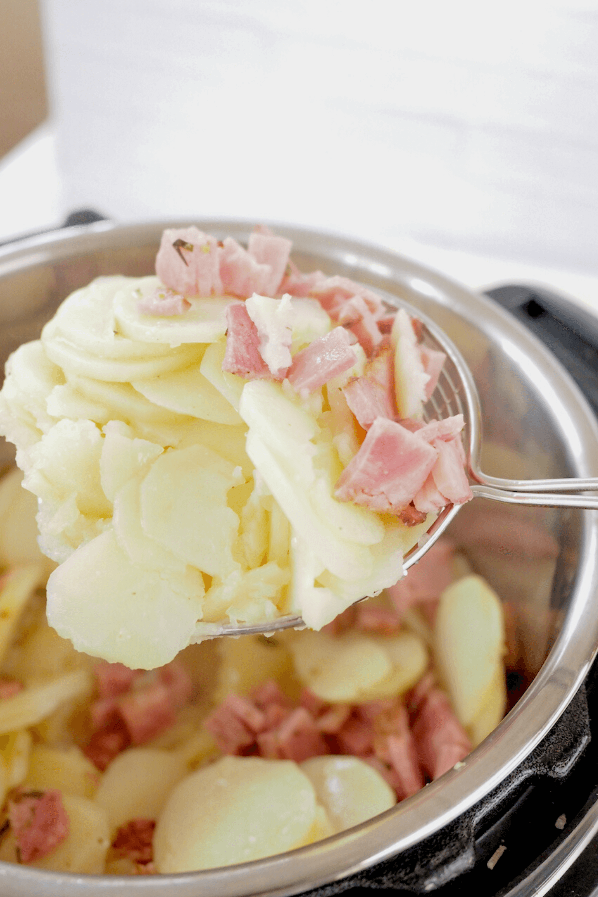 https://www.thefreshcooky.com/wp-content/uploads/2022/04/Using-ladel-to-pull-out-cooked-potatoes-and-ham.png