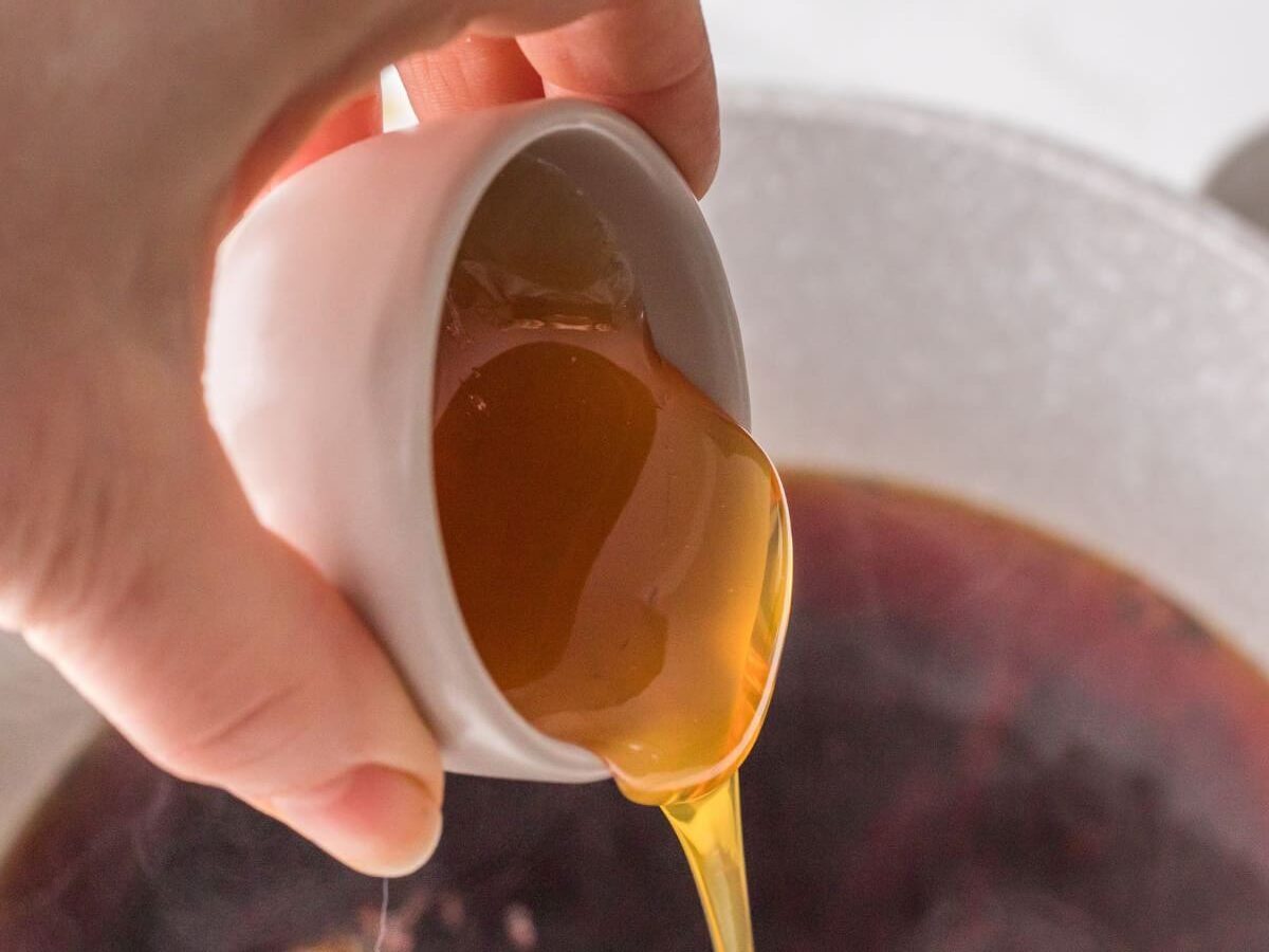 Pouring honey into chai concentrate.