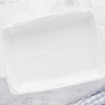 A 9x13-inch baking dish is lined with parchment paper.