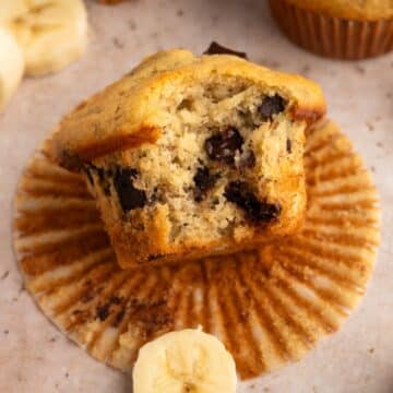 Banana chocolate chunk muff with bite removed on muffin liner.